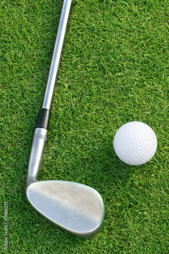 Golf Ball And Club On The Green