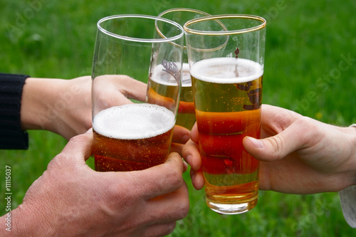 three glass with beer in men hands