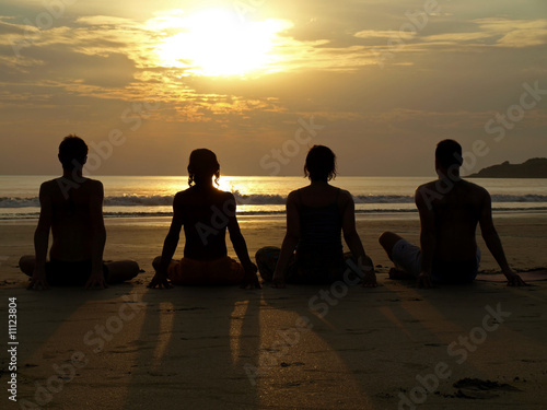 Yoga at sunset by the ocean