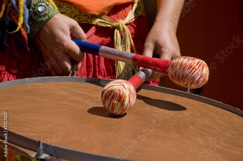 Women playing the orange drum.