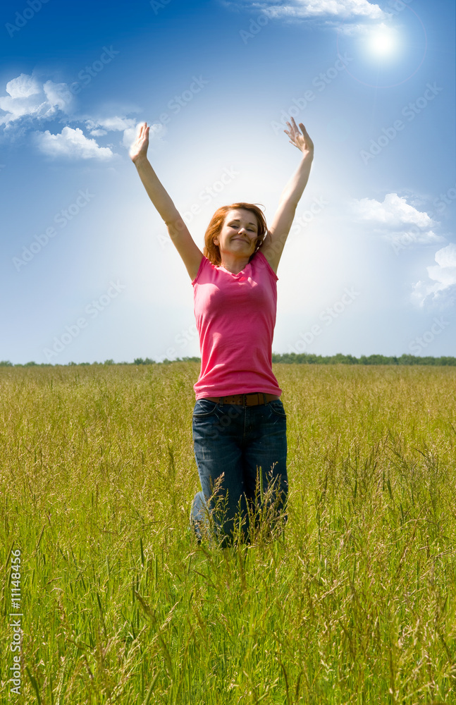 beautiful spreading her arms in the middle of a field beautiful spreading her arms in the middle of a field