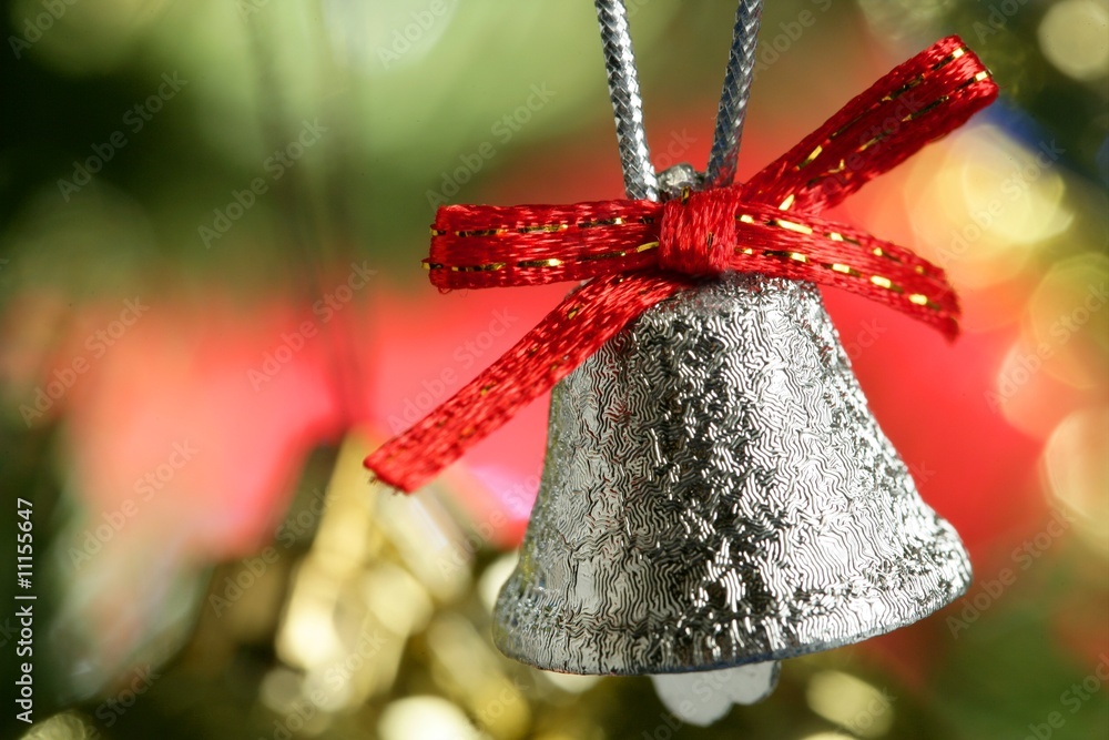 Silver bell in the christmas tree with red ribbon Silver bell in the christmas tree with red ribbon