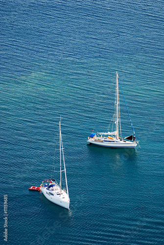 Two white yachts on the blue sea © lite