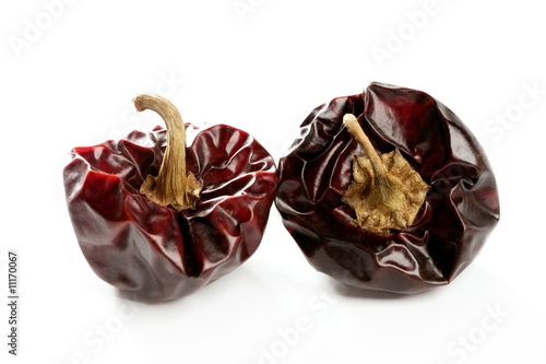 Two round Mediterranean dried dark red peppers