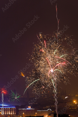 Fireworks rocket in the night sky on New Year's Ev photo