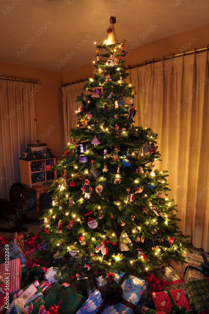 Christmas tree with lights and ornaments with presents