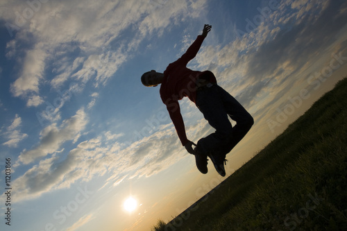 Wallpaper Mural silhouette of a teenager jumping against blue sky at sunset Torontodigital.ca