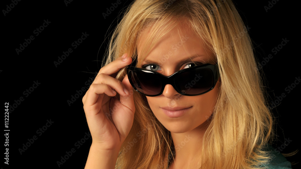 Beautiful woman with blonde hair looking over sunglasses. Beautiful woman with blonde hair looking over sunglasses.