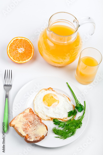 breakfast meal with fried egg and a jug of orange juice