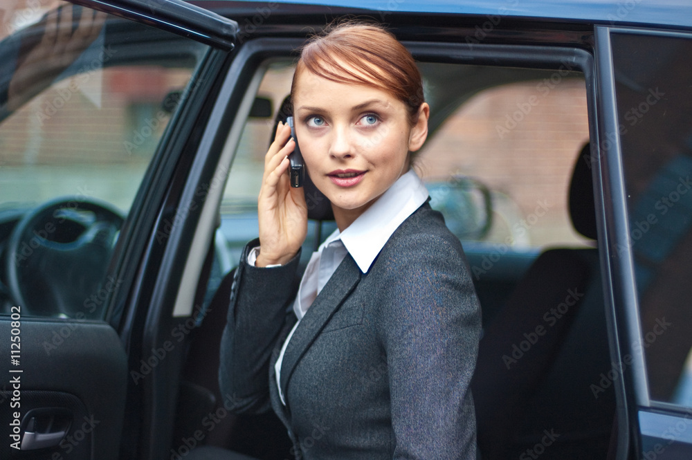 Business woman with phone and car Business woman with phone and car