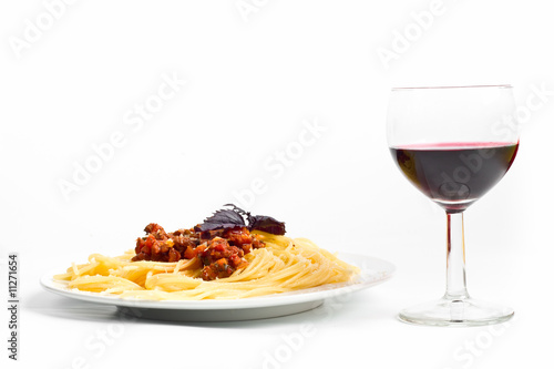 one serving of spaghetti bolognese with a glass of red wine