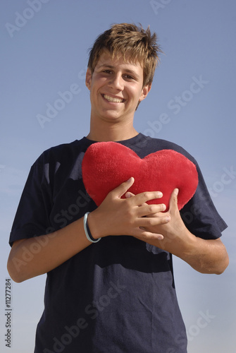 boy in love holding a big red heart