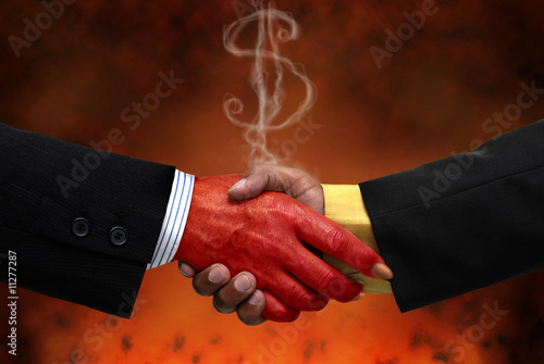 Businessman making a pact with the devil