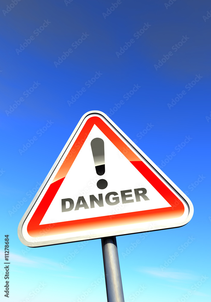 Danger - exclamation point sign against the blue sky Danger - exclamation point sign against the blue sky