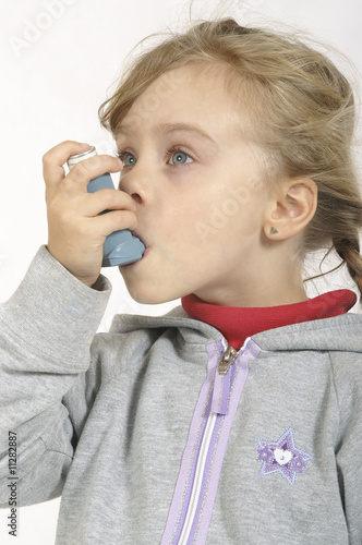 Small girl inhaling medicine