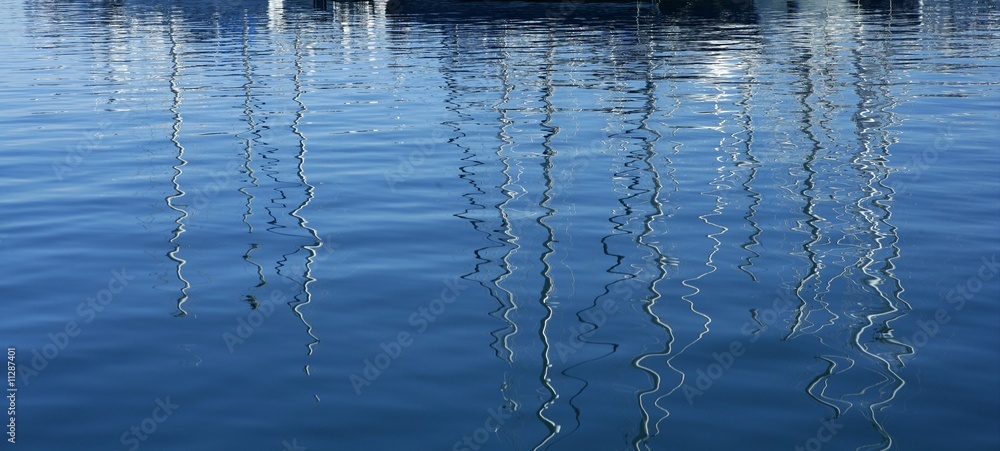 Boats abstract reflexion over blue water