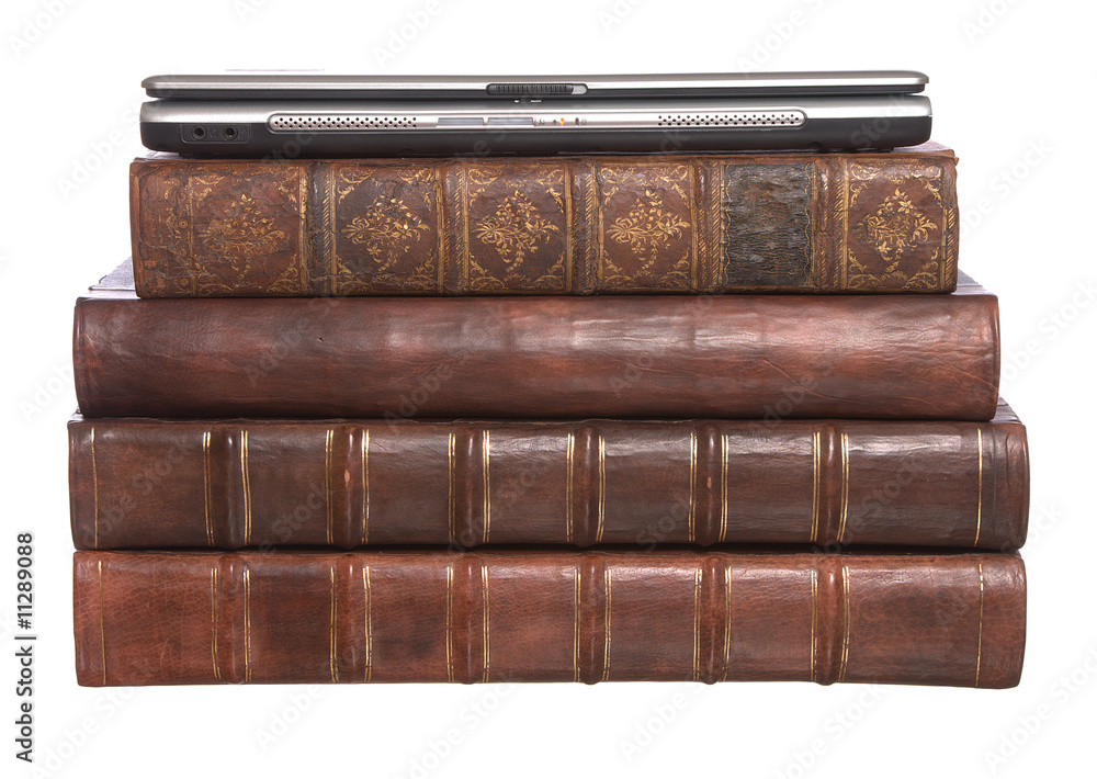 Pile of old leather bound books with a laptop Pile of old leather bound books with a laptop