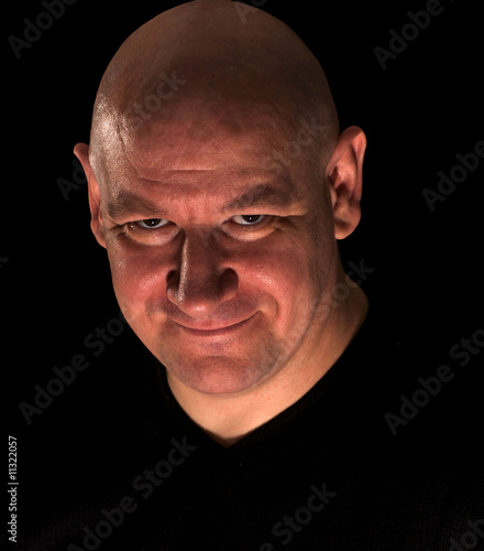 Sinister looking bald headed man photo