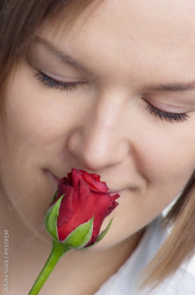 portrait of a beautiful woman smelling red rose portrait of a beautiful woman smelling red rose