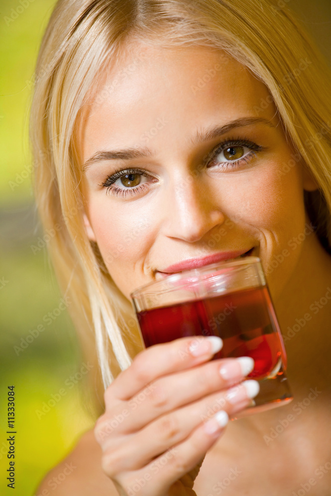 Young beautiful woman with glass of juice, indoors Young beautiful woman with glass of juice, indoors