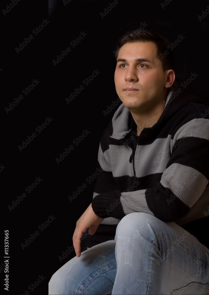 Young man thinking on a black background Young man thinking on a black background