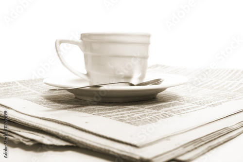 Cup coffee on a morning paper business news