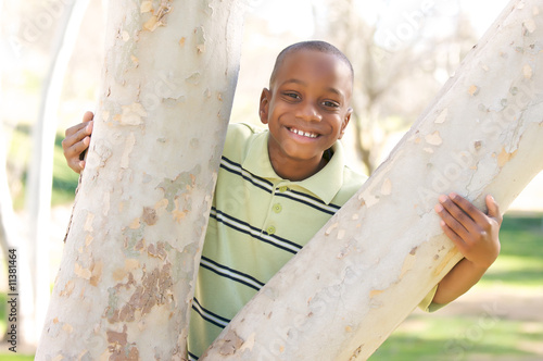 Young Boy Hugs a Tree