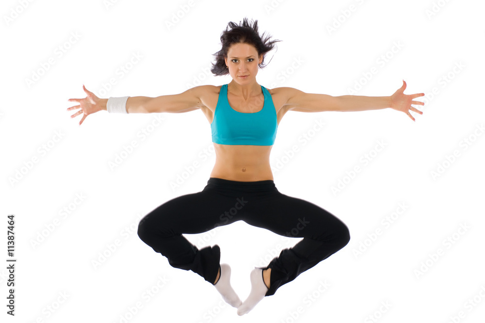 A beautiful fitness with flat ABs in a high jump of power