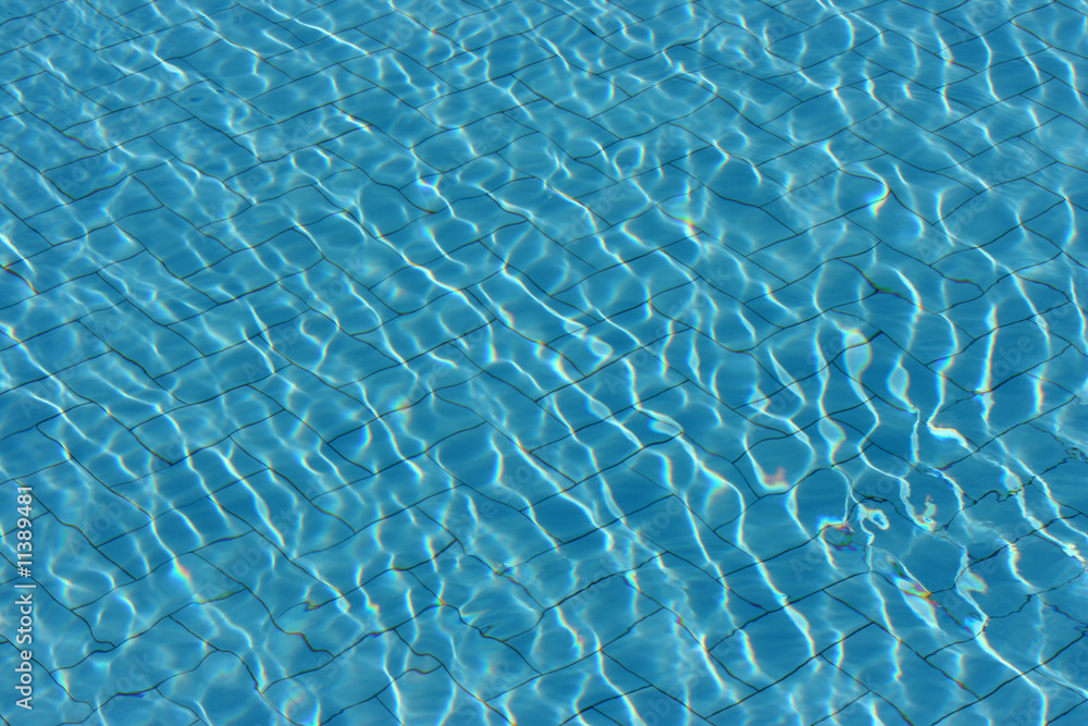 A close up shot of some pool water as the sunlight reflection
