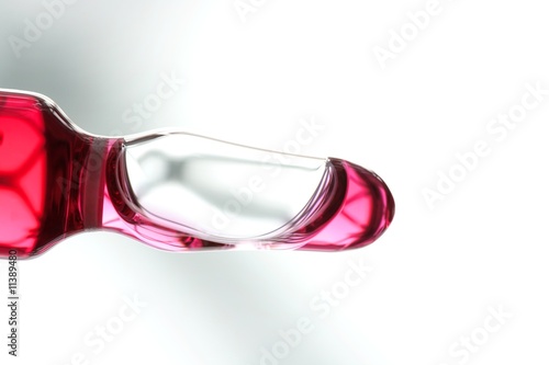 Glass ampoule with red liquid medicine