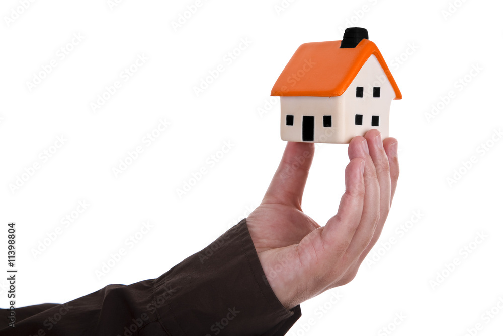 human hand holding a small house human hand holding a small house