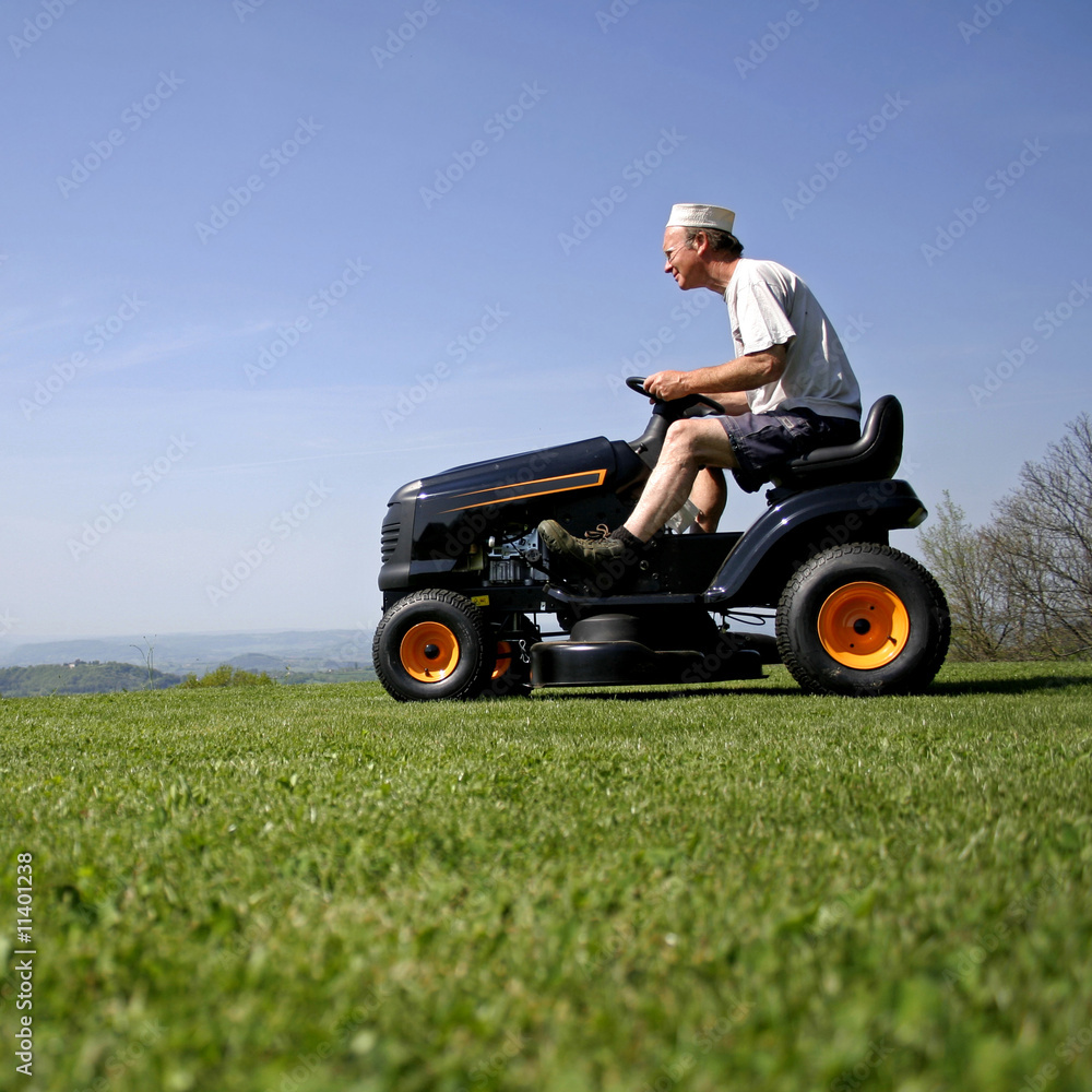 man sitting on a lawnmower