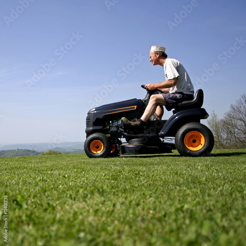 man sitting on a lawnmower