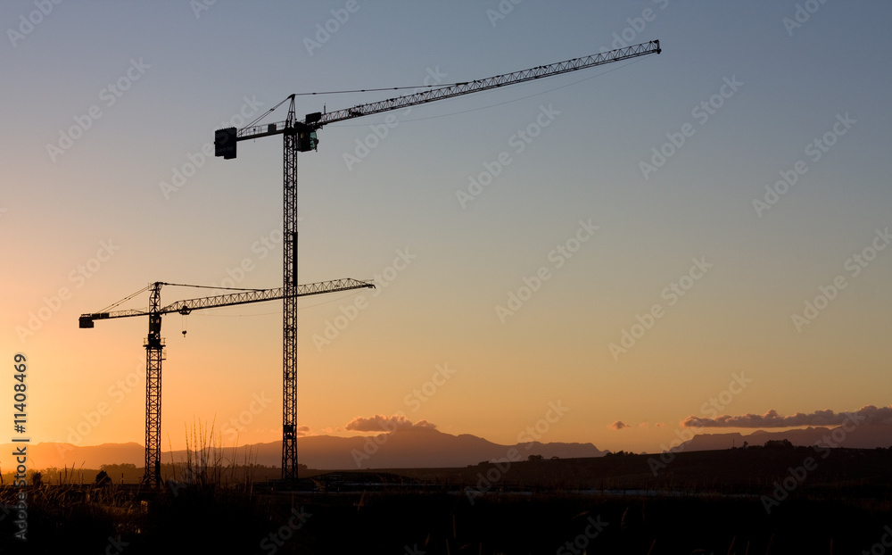 high cranes at sunset