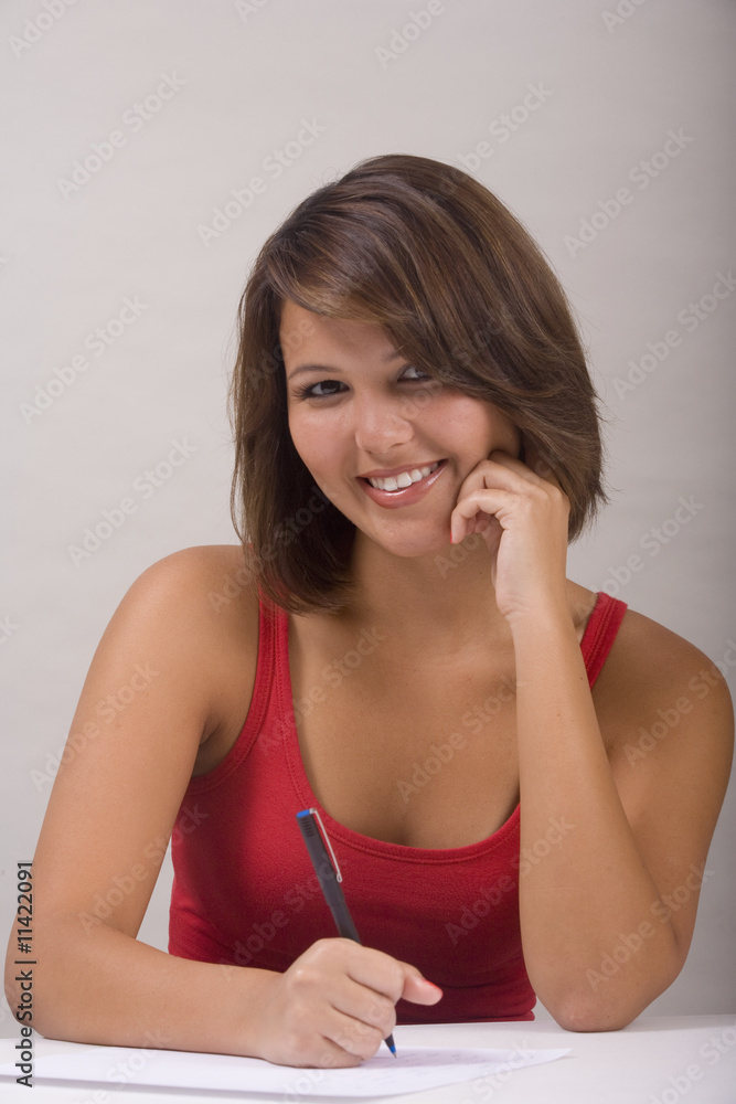 A beautiful young Asian-American woman writing a letter A beautiful young Asian-American woman writing a letter