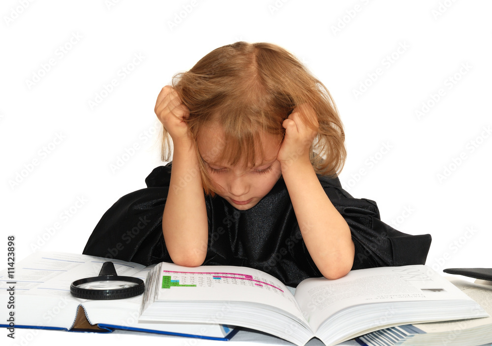Cute little girl is reading textbooks in a graduation dress Cute little girl is reading textbooks in a graduation dress
