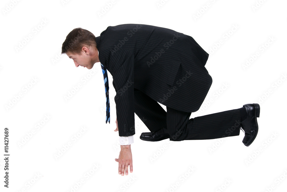 Businessman getting ready for race in business Businessman getting ready for race in business