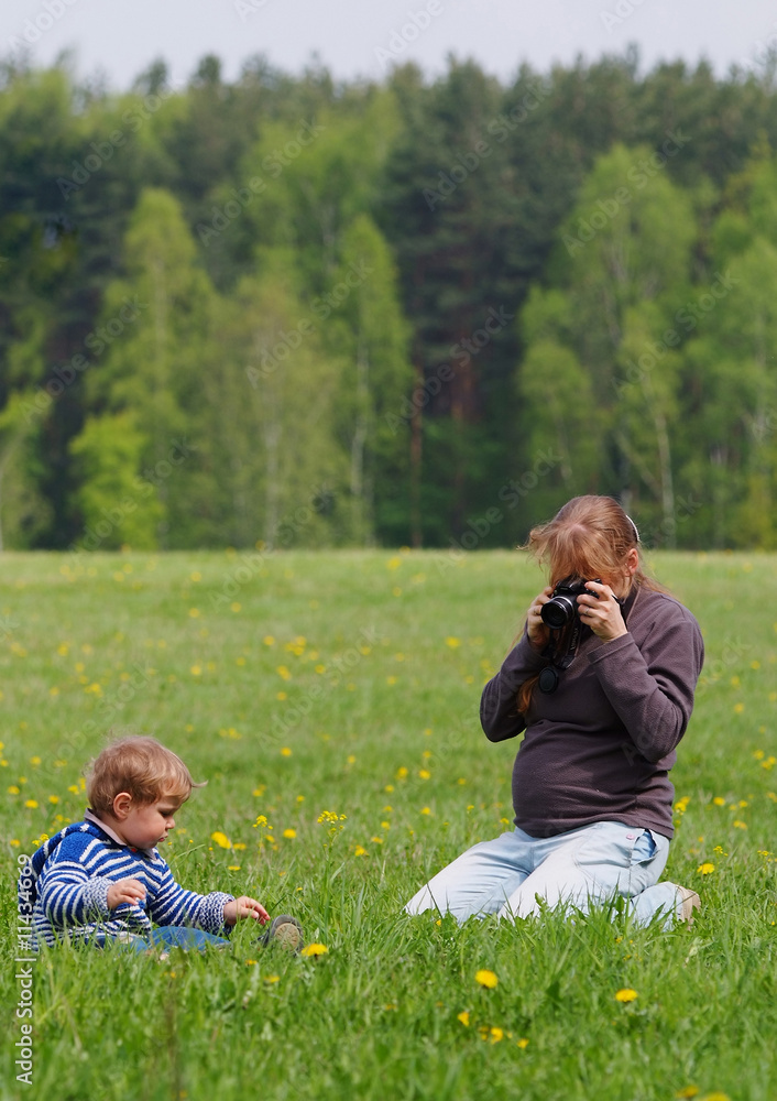 young pregnant photographer woman with her son young pregnant photographer woman with her son