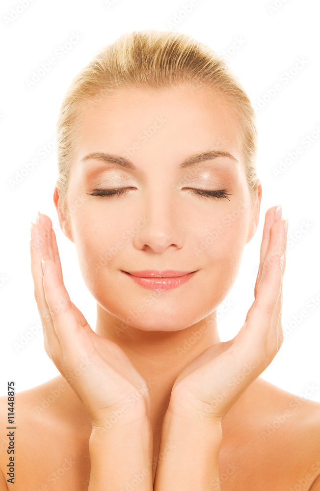 Beautiful young woman massaging her face Beautiful young woman massaging her face