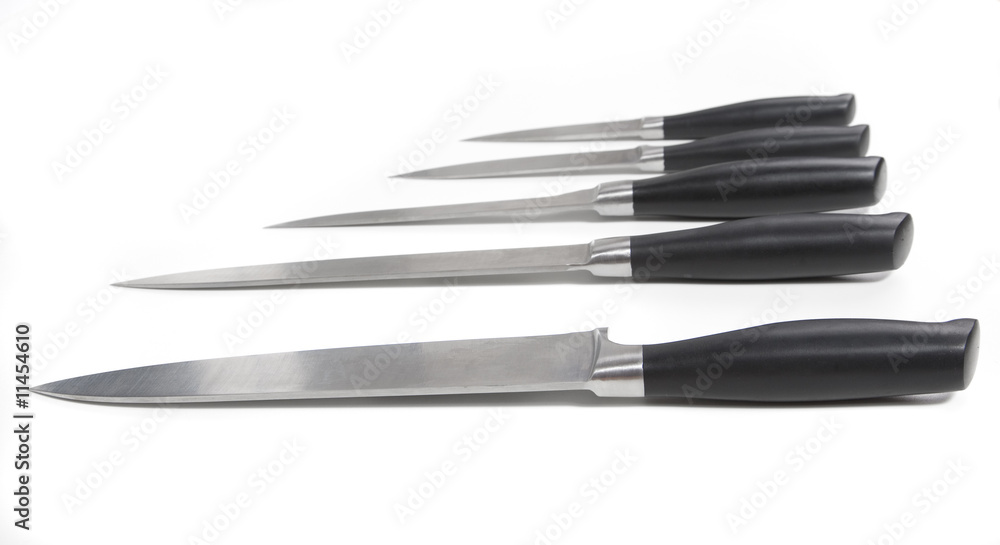 A small collection of kitchen knives. 5 different knives on whit A small collection of kitchen knives. 5 different knives on whit