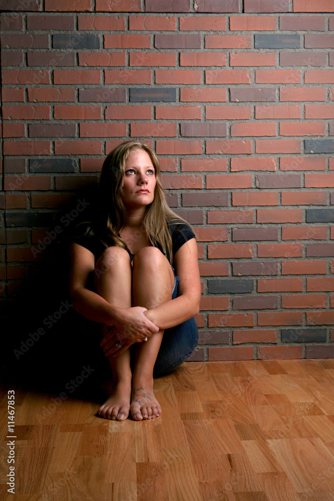 beautiful woman sitting depicting the concept of depression beautiful woman sitting depicting the concept of depression