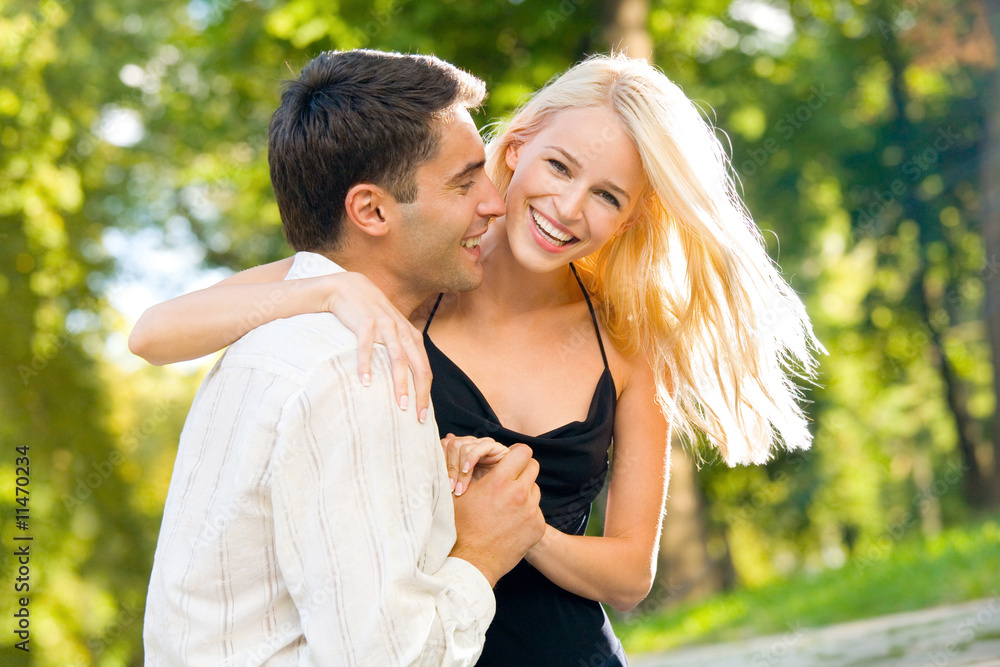 Young happy smiling couple walking outdoors together