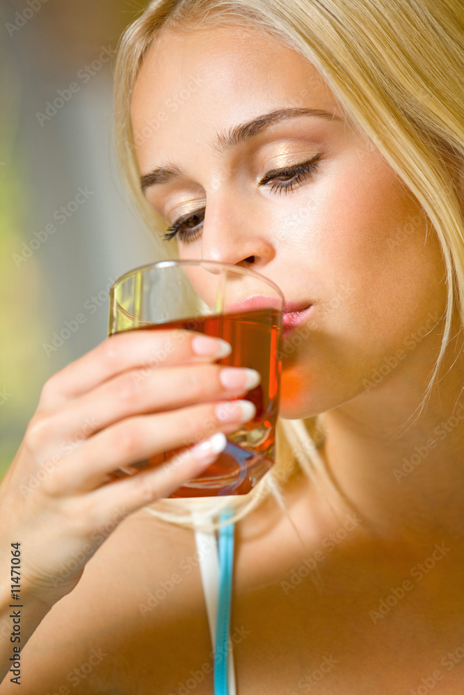 Portrait of young beautiful woman with glass of juice, indoors Portrait of young beautiful woman with glass of juice, indoors
