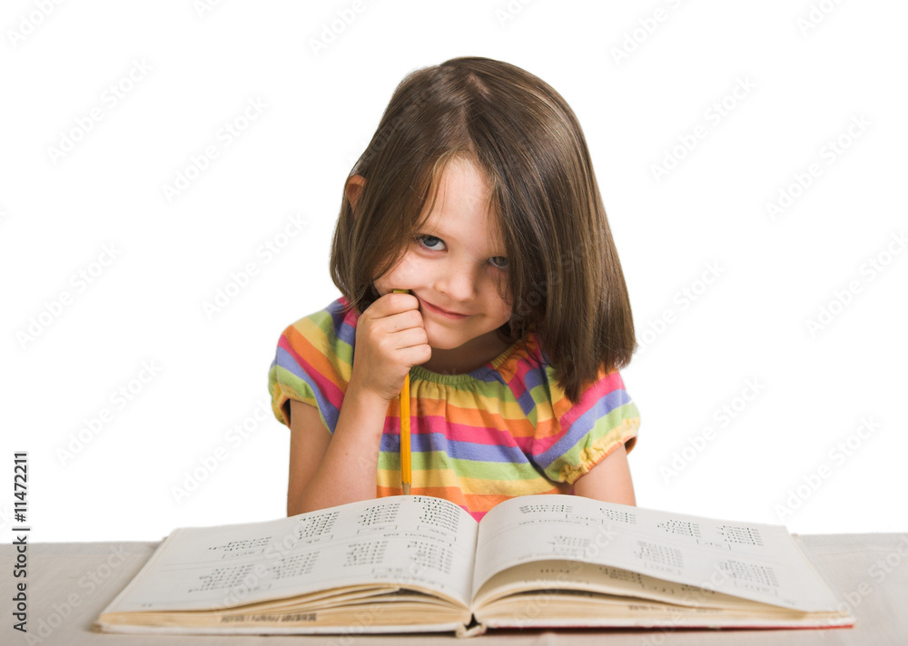 little girl studying from book