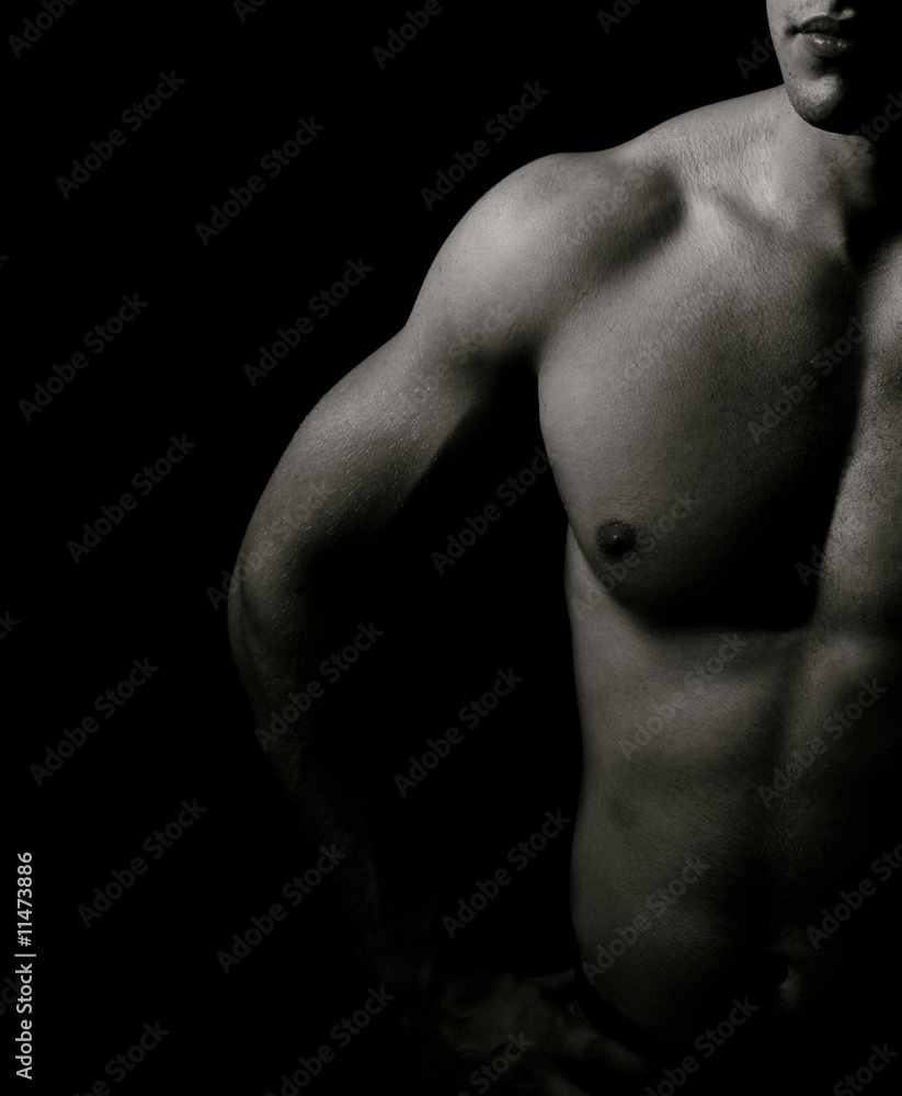 Muscle man fit torso over black background Muscle man fit torso over black background