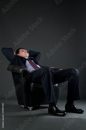 relax of the businessman on dark background