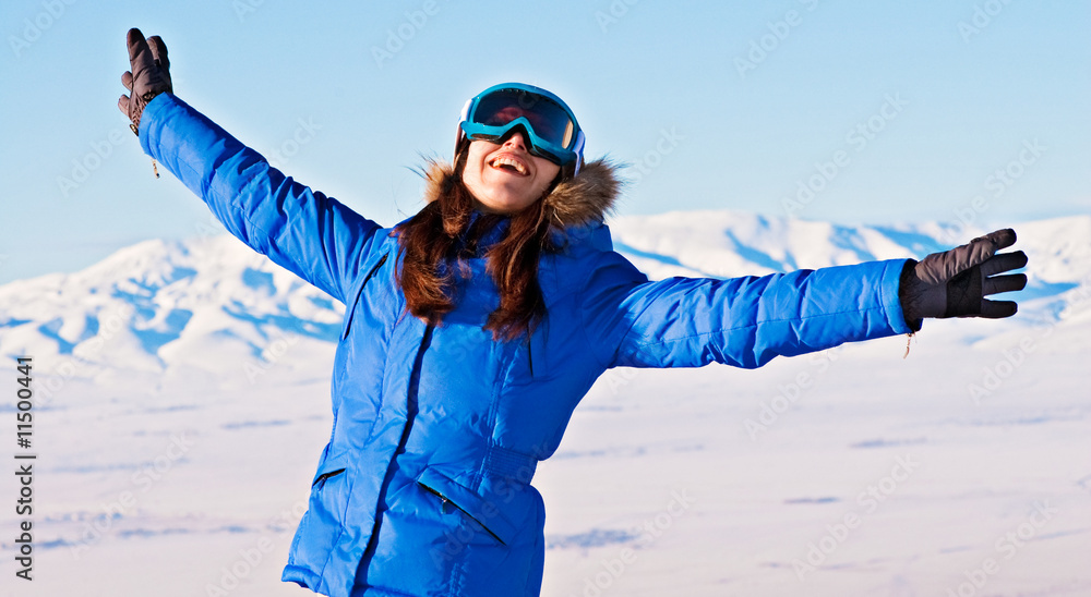 happy woman against snowy mountains