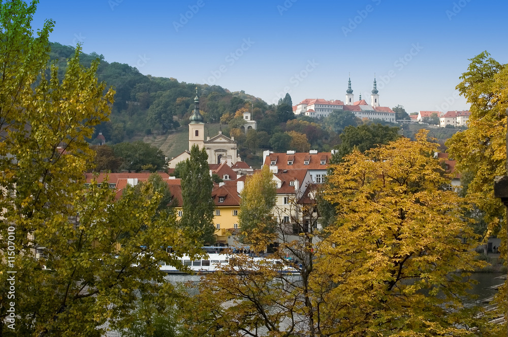 View  on autumn Prague through foliage