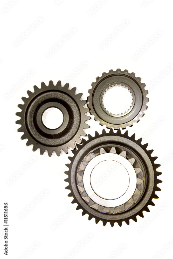 Three cog gears meshing together over white Three cog gears meshing together over white
