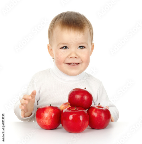 Cute child and apples on the table